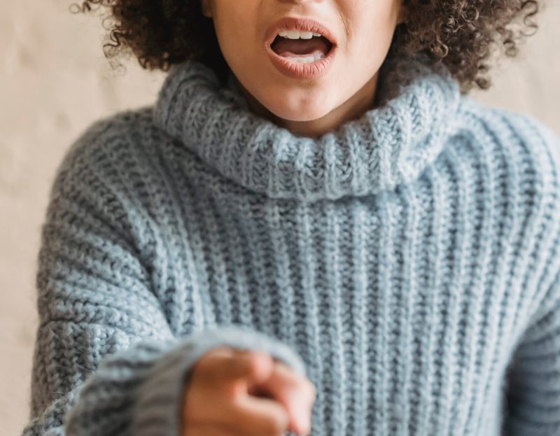Angry black woman pointing at camera