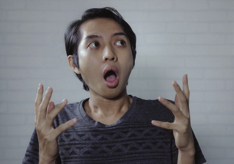 Asian man look side with amazed expression