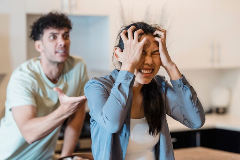Stressed woman holding her head