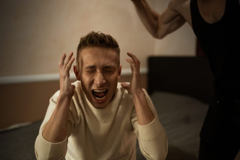 A man in white long sleeve shirt screaming