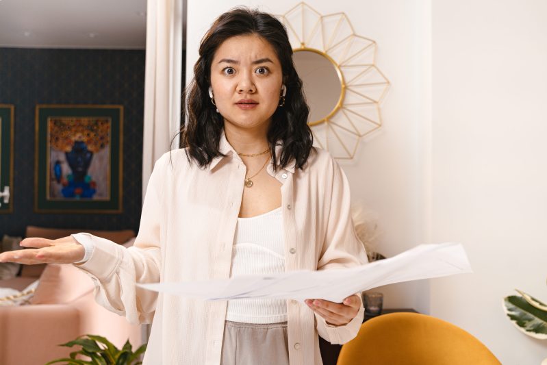 Portrait of shocked woman in living room