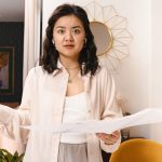 Portrait of shocked woman in living room