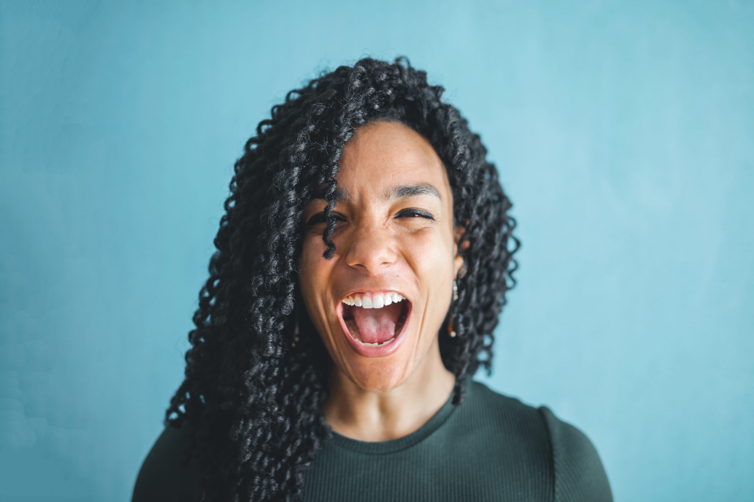 Woman in knitted shirt is screaming
