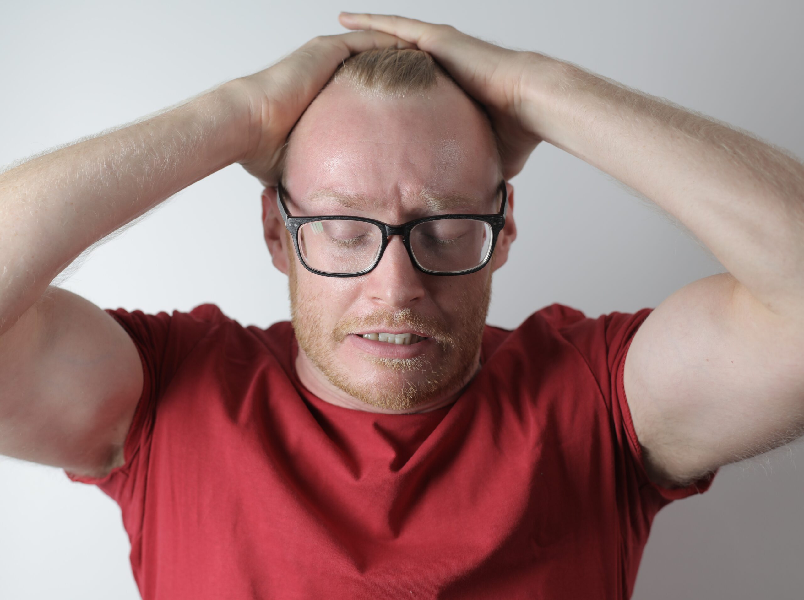 Upset male with headache taking break after intensive work