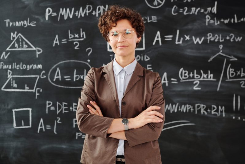Photo of woman standing in front of blackboard