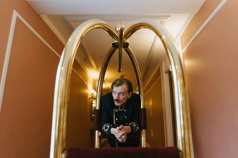 Porter leaning on a trolley