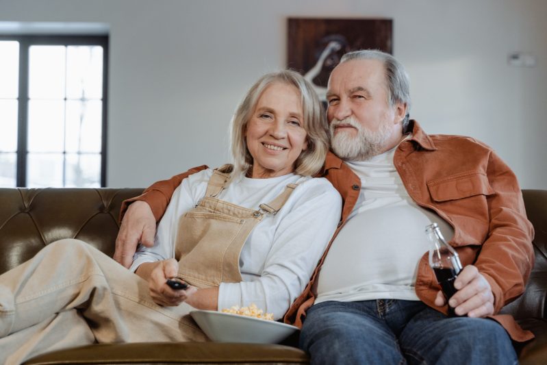 Man and woman sitting on couch