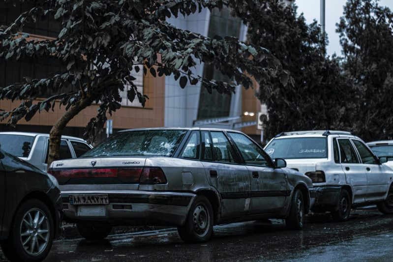 a line of parked cars on a city street