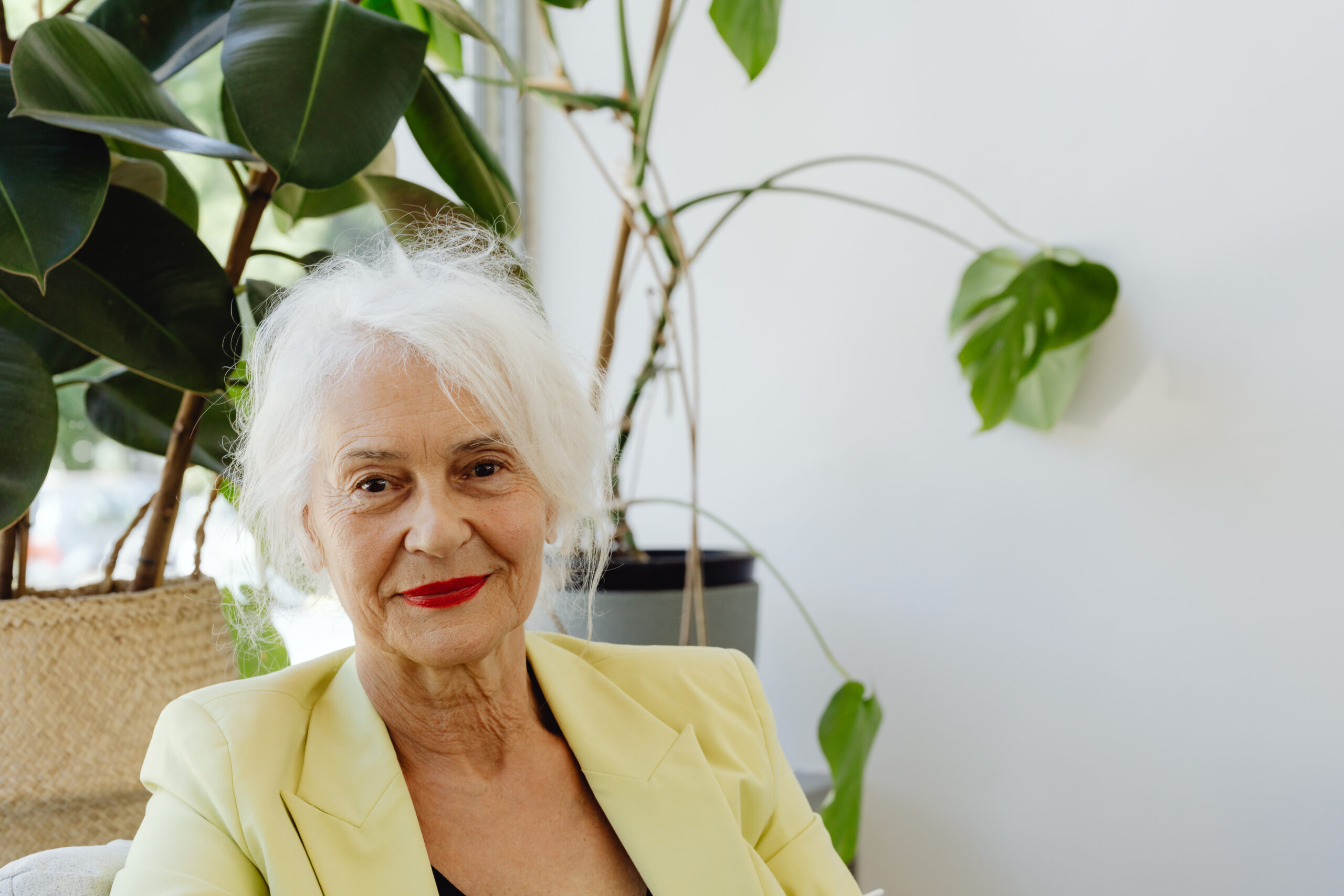 A smiling lady in a yellow blazer