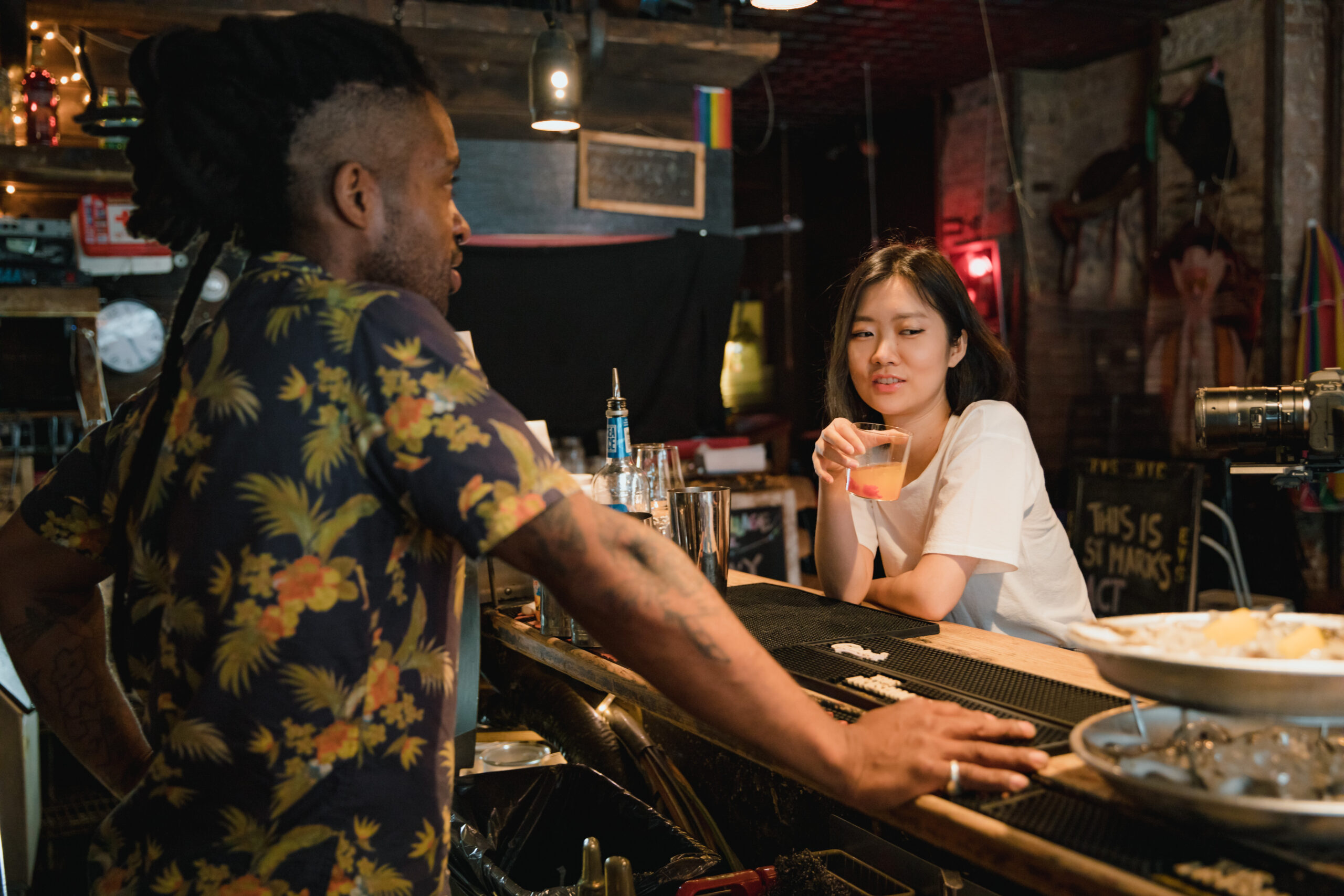 Tbartender and customer talking at bar