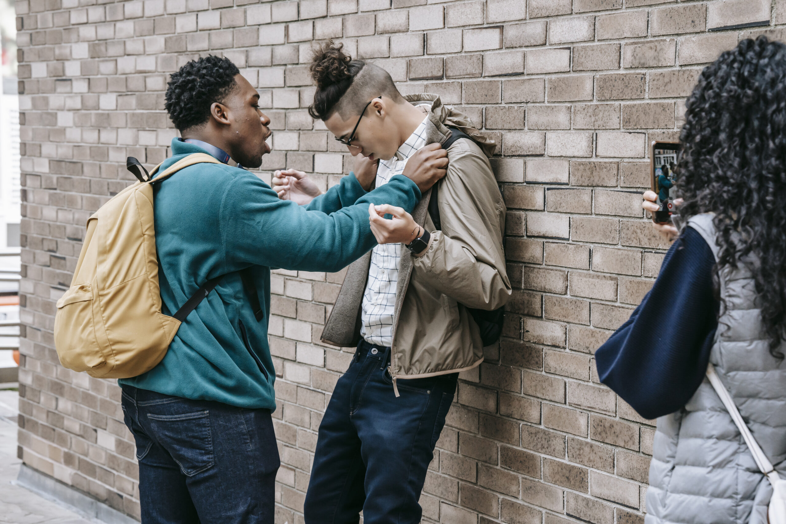 Multiethnic students having conflict on street