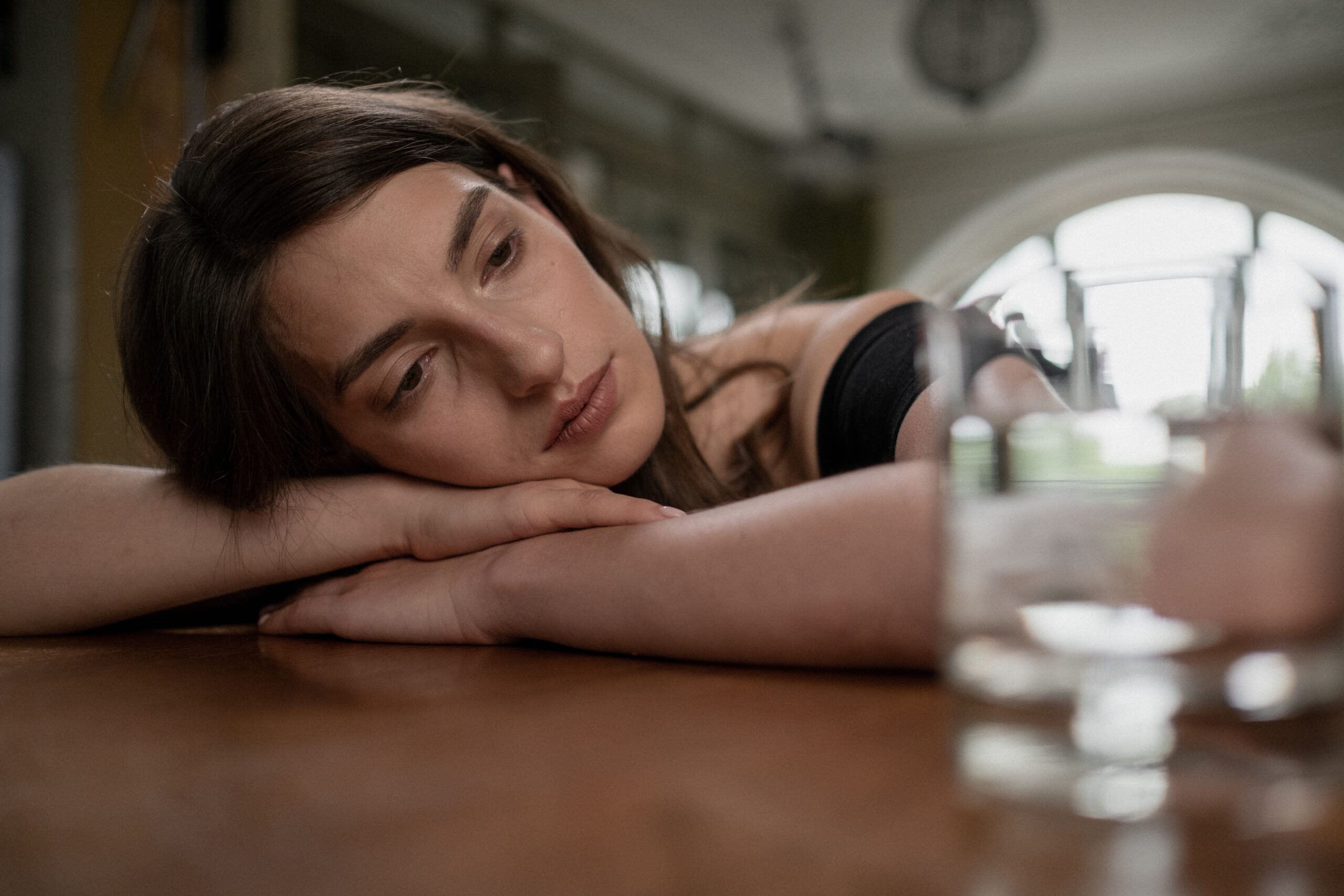 Sad woman on a wooden table