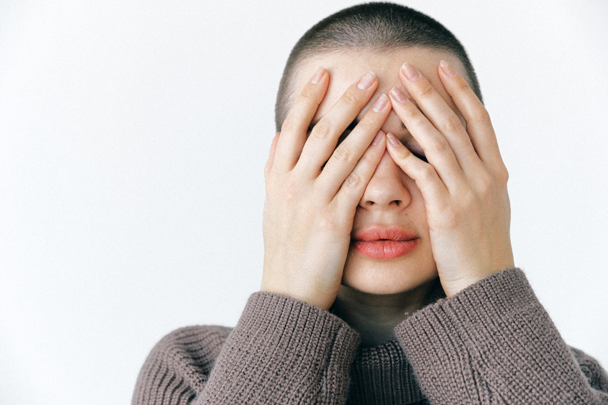 Woman covering her face