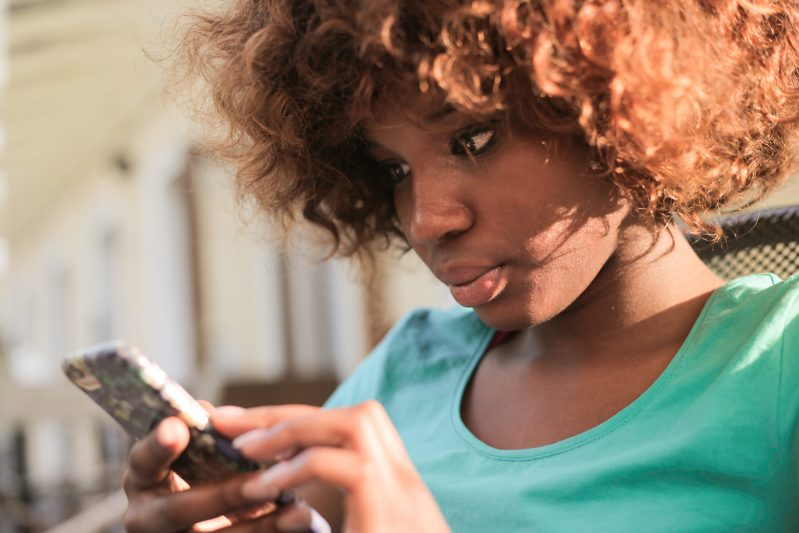 Woman using smartphone during daylight