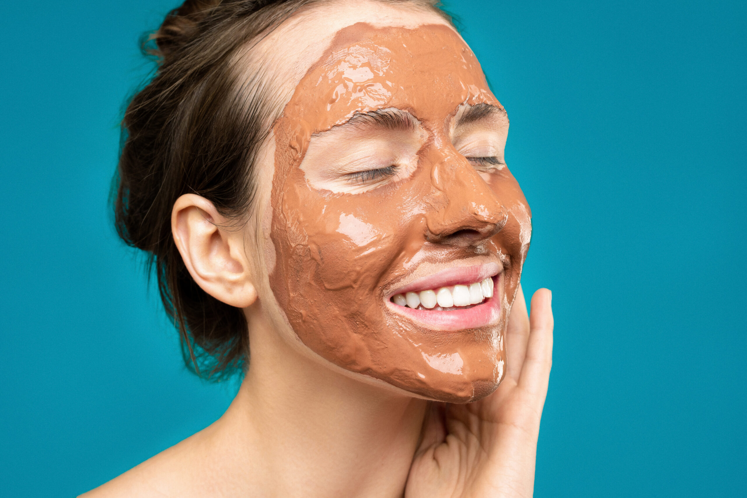 Woman with clay mask on face