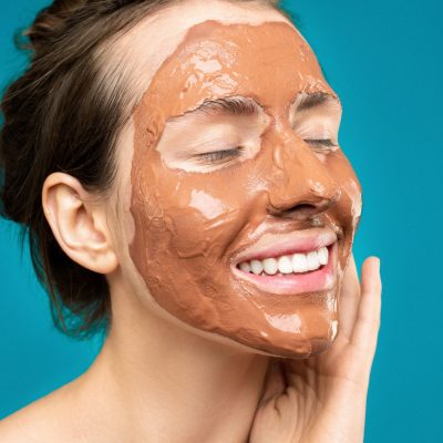 Woman with clay mask on face